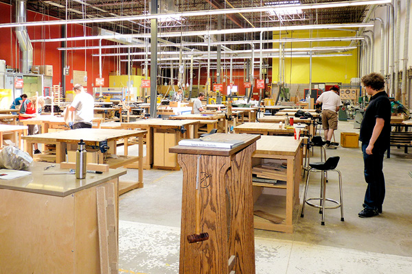 people standing in woodworking shop