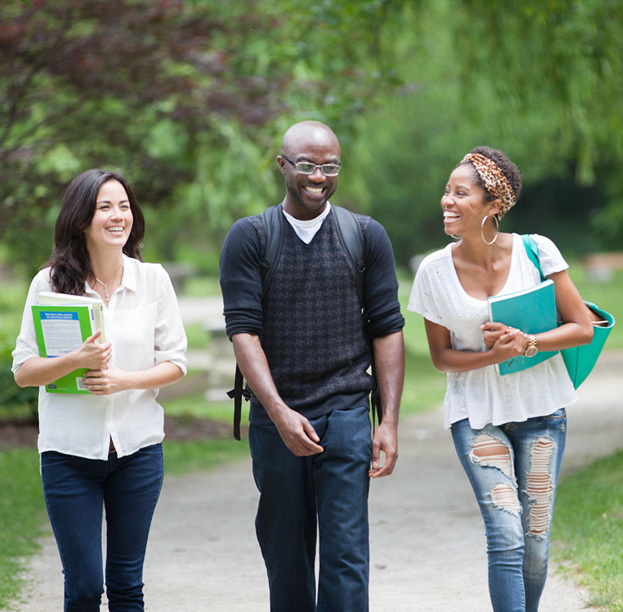 three students walking outside talking