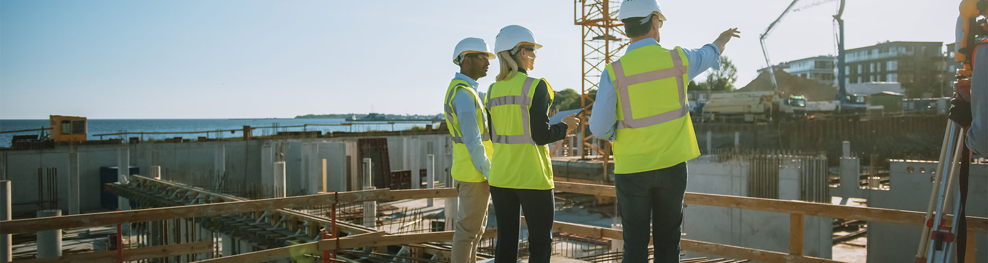 Three construction workers on top of a building