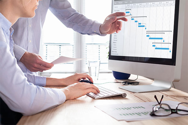 people pointing to monitor