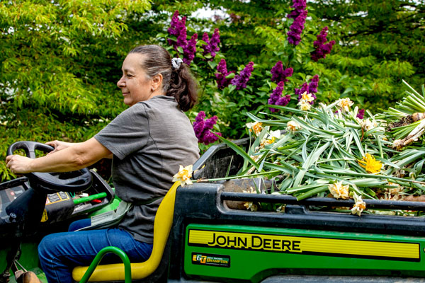 Person driving John Deere mini tractor