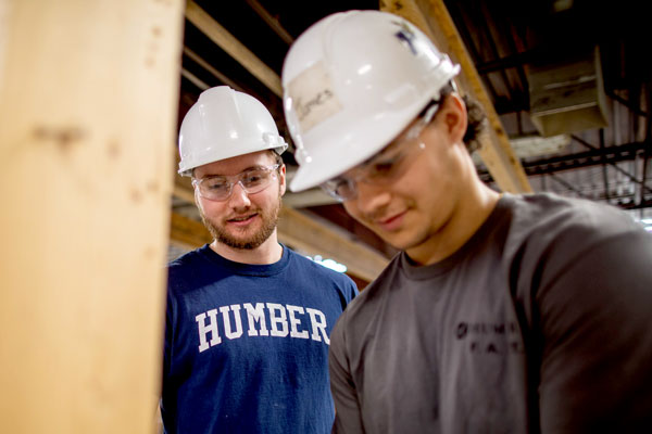 Two Humber students wearing hard hats