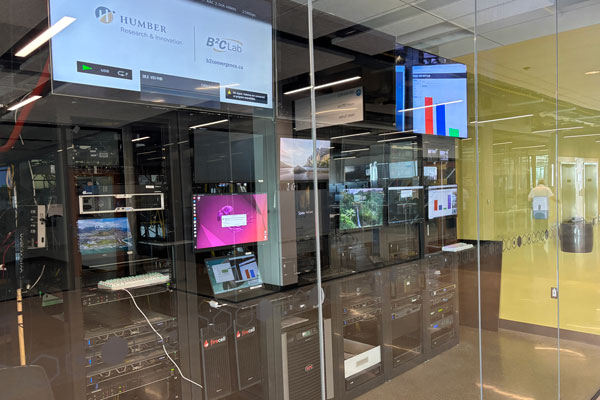 Computer lab with monitors behind glass wall