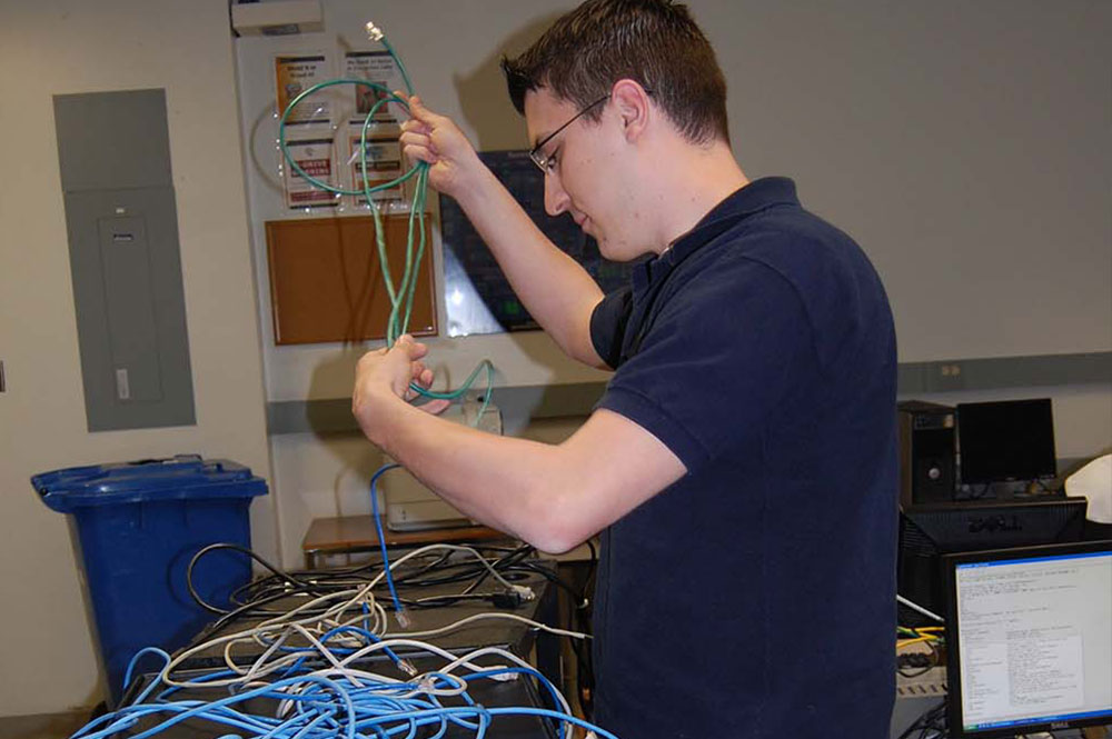 person holding computer wires