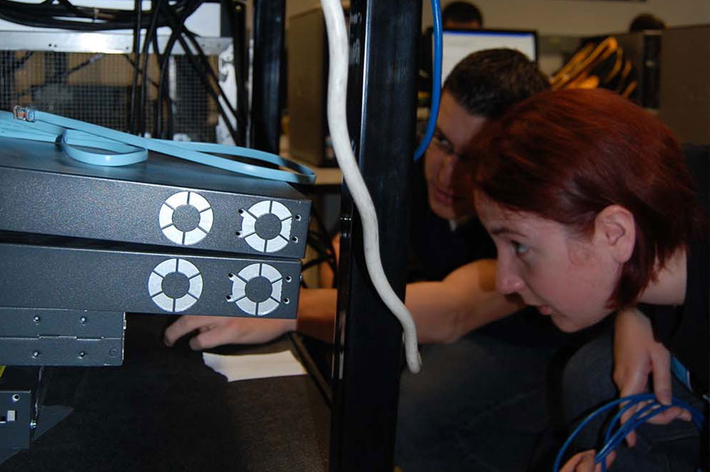 student and teacher looking at computer