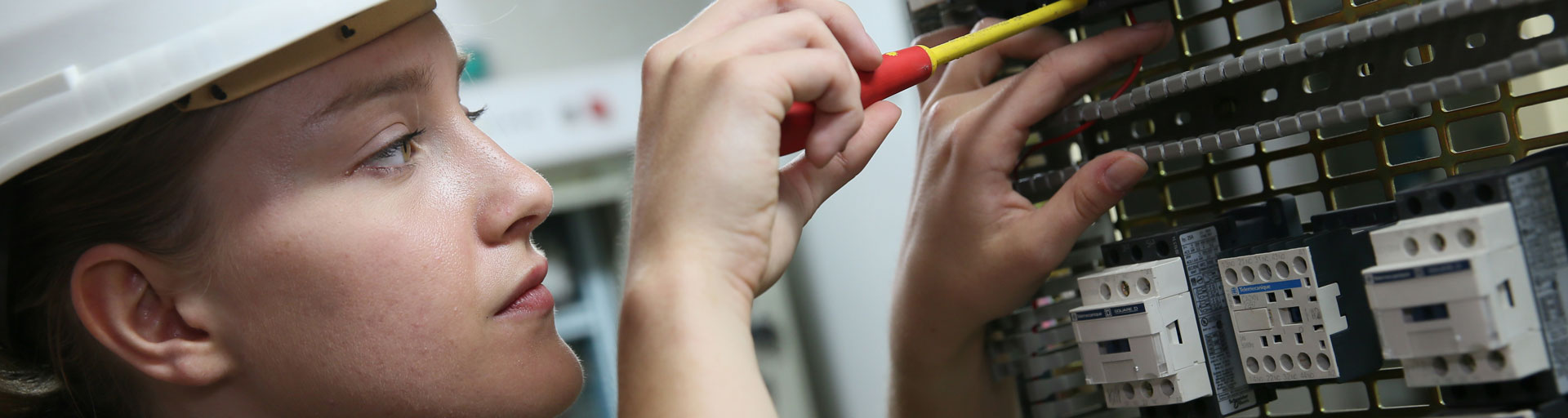 student working on electrical panel