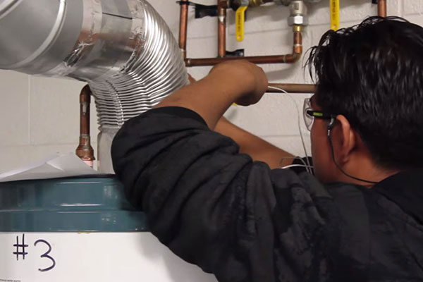 male checking heating equipment