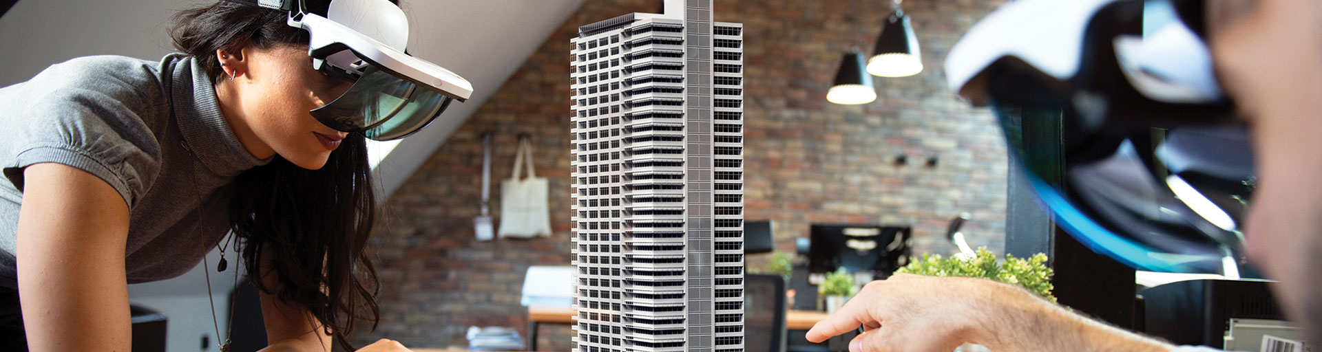 two people looking at physical scale model of building