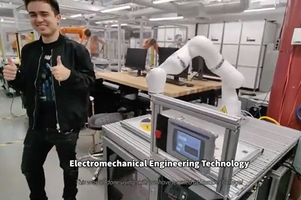 person giving thumbs up next to a robot arm