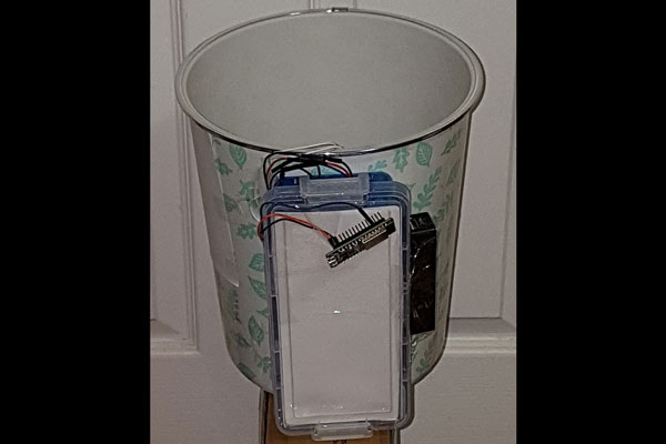 trash can with electronics component attached