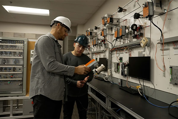 Two people looking at equipment